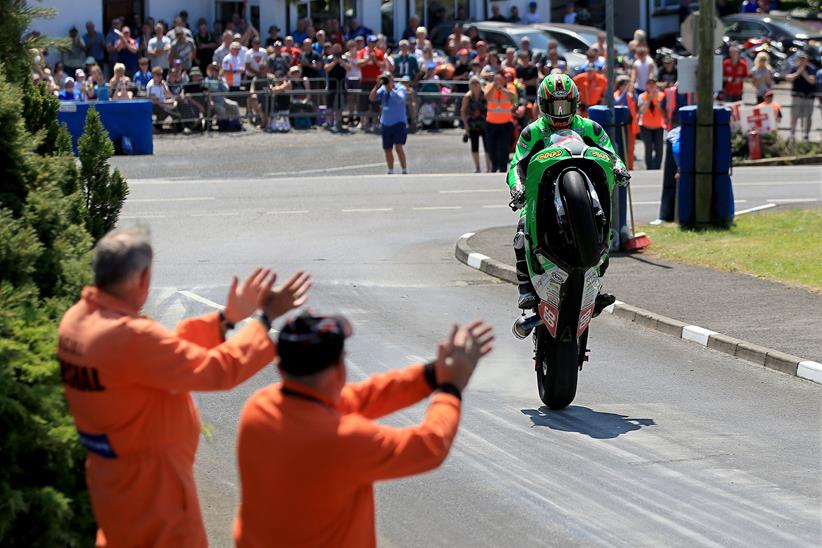 A racer celebrates with a wheelie in Enniskillen