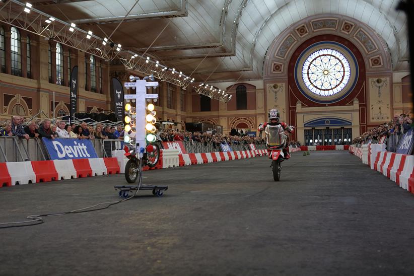 John McGuinness pulls a wheelie on the sprint course