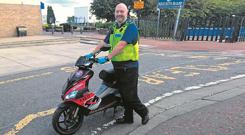 Policeman with recovered scooter