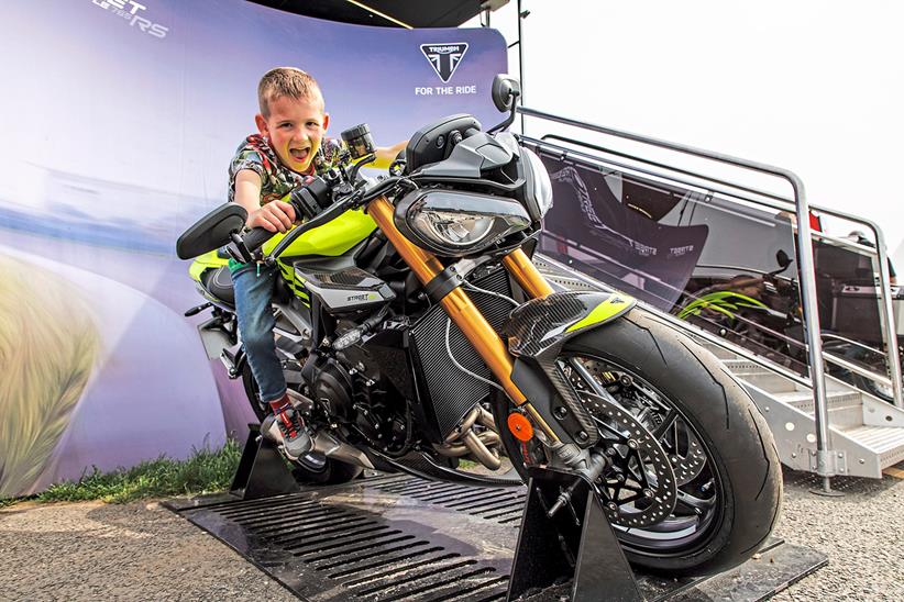 Young visitor tries a Triumph Street Triple for size at the 2023 MCN Festival of Motorcycling