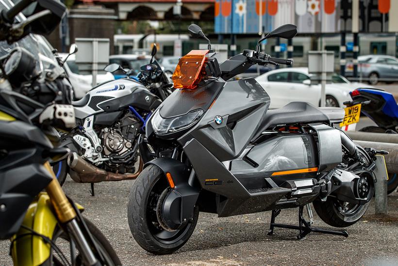 BMW CE-04 parked up with petrol commuters at a train station