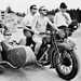 Steve McQueen riding a motorbike and sidecar