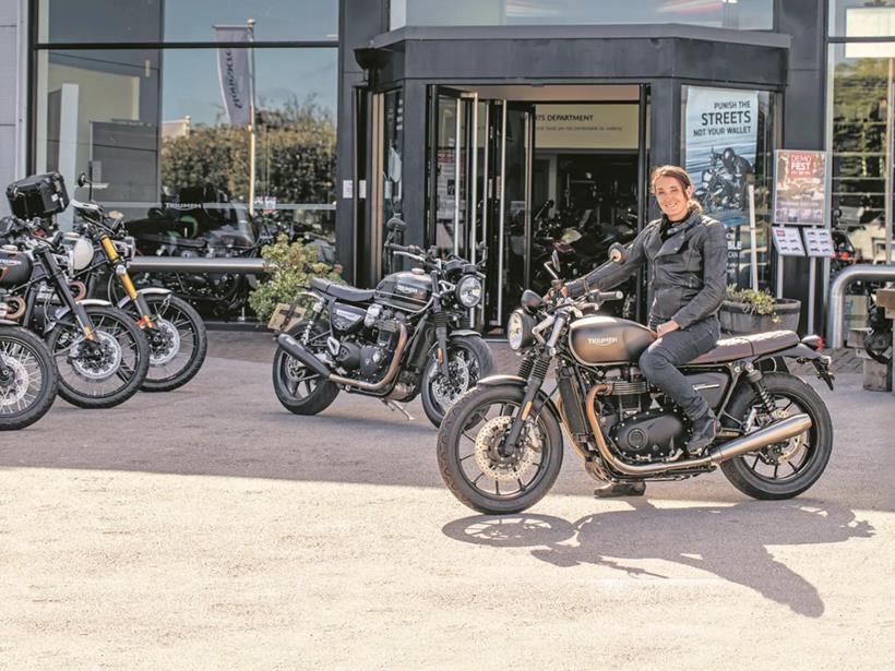 Emma sits with the Triumph Street and Speed Twins