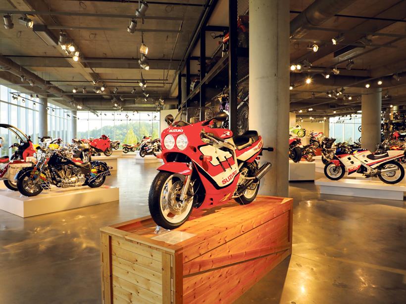 An original GSX-R750 Slingshot, exactly as it would have left the crate, right down to the fresh-from-the-mould Michelin A59/M59X rubber. Over on the left is the opaque screened Ducati Paso, a Suzuki GSX-R1000K3 and hard top BMW C1 scooter. Over on the other side there’s a Ducati Desmosedici RR, Bimota DB5, Kawasaki KR-1S, Suzuki RGV250K Honda NC30, Yamaha R1M and Honda VFR750 Interceptor...