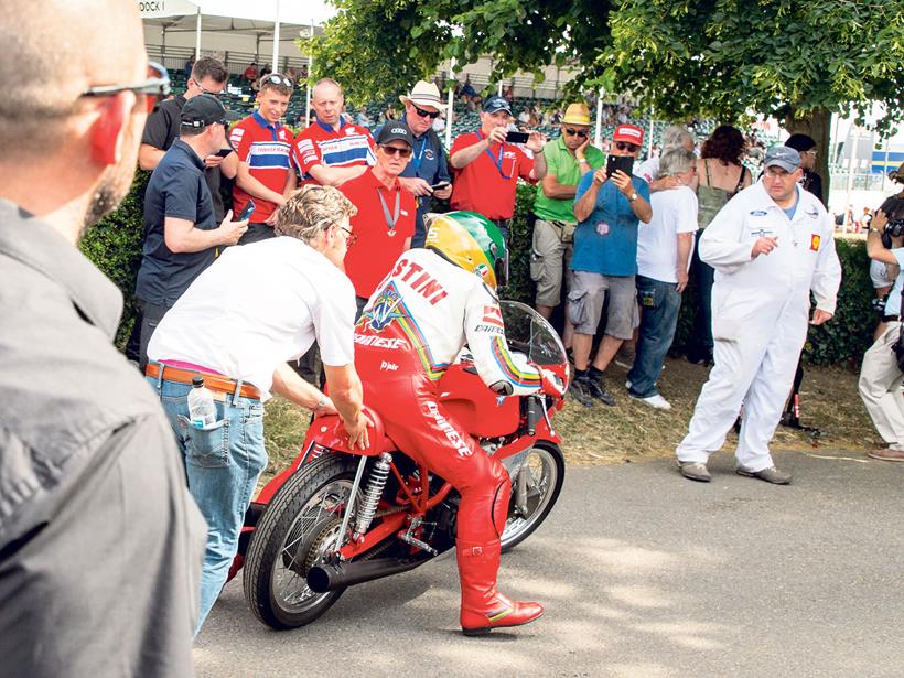 Giacomo Agostini gets a push start on his MV Agusta