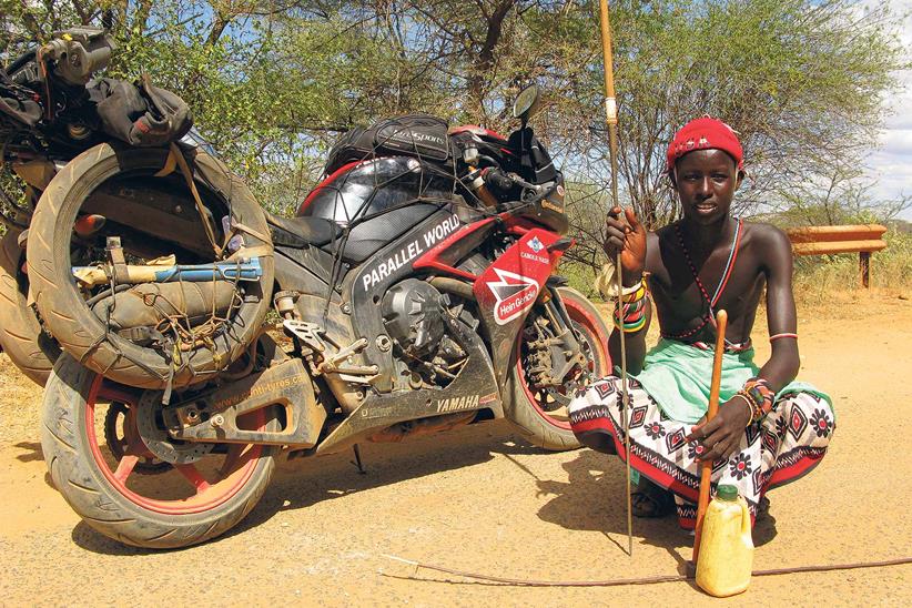 A Kenyan tribesman poses with Sanders' Yamaha R1