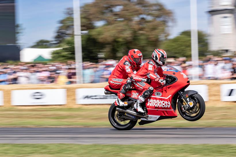 Randy Mamola gives a passenger ride at Goodwood