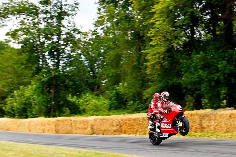 Randy Mamola pulls a wheelie two-up on the MotoX2