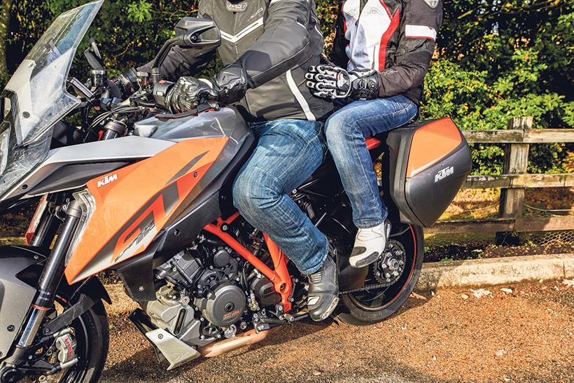 There are a couple of ways to hold on while riding pillion on a motorbike