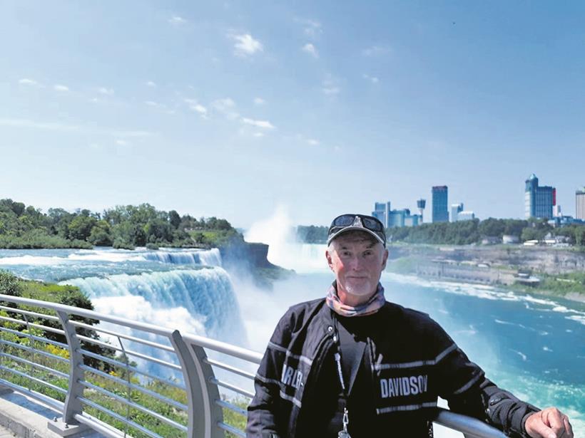 Gordon poses by a waterfall