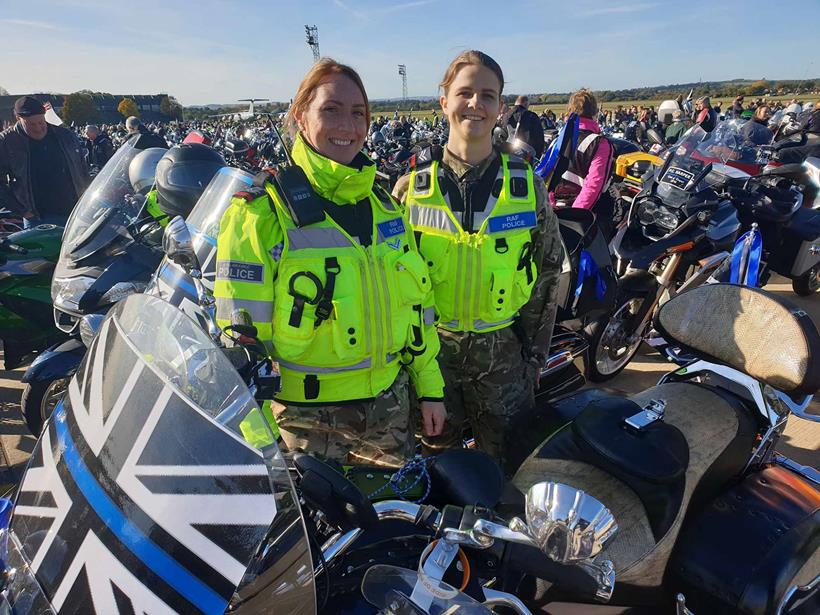 RAF police pose with a motorcycle