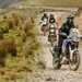 2022 Aprilia Tuareg 660 riding on a gravel trail in a rally