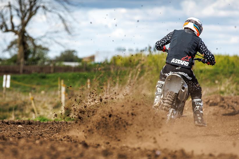 2024 Triumph TU250X Carl Stevens cornering on a motocross track