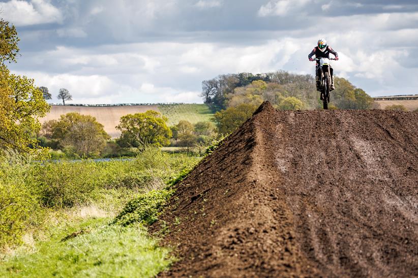 2024 Triumph TU250X Carl Stevens jumping on a motocross track