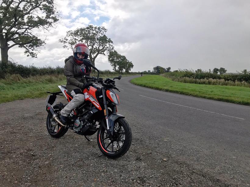 Maria with the KTM 125 Duke hoping the weather doesn't break