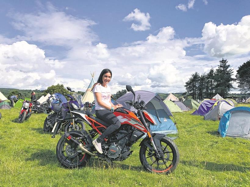 Maria and the KTM 125 Duke relaxing at Camp VC