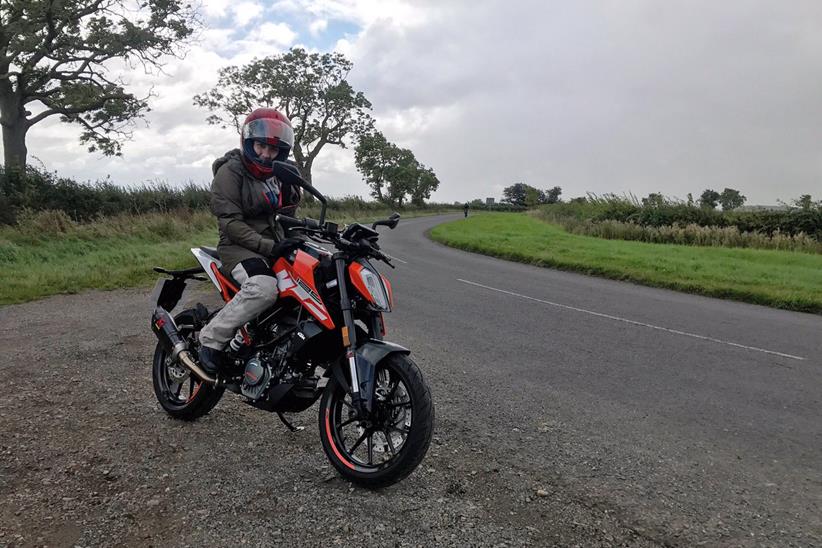 Maria with the KTM 125 Duke hoping the weather doesn't break