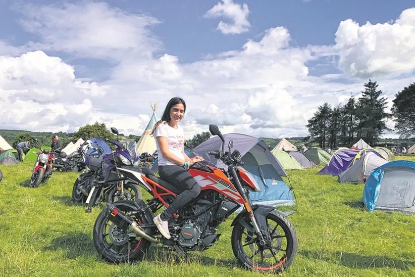 Maria and the KTM 125 Duke relaxing at the Camp