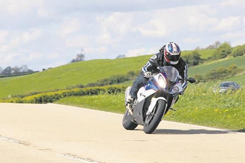 BMW S1000RR ridden at speed on road cornering, testing the handling