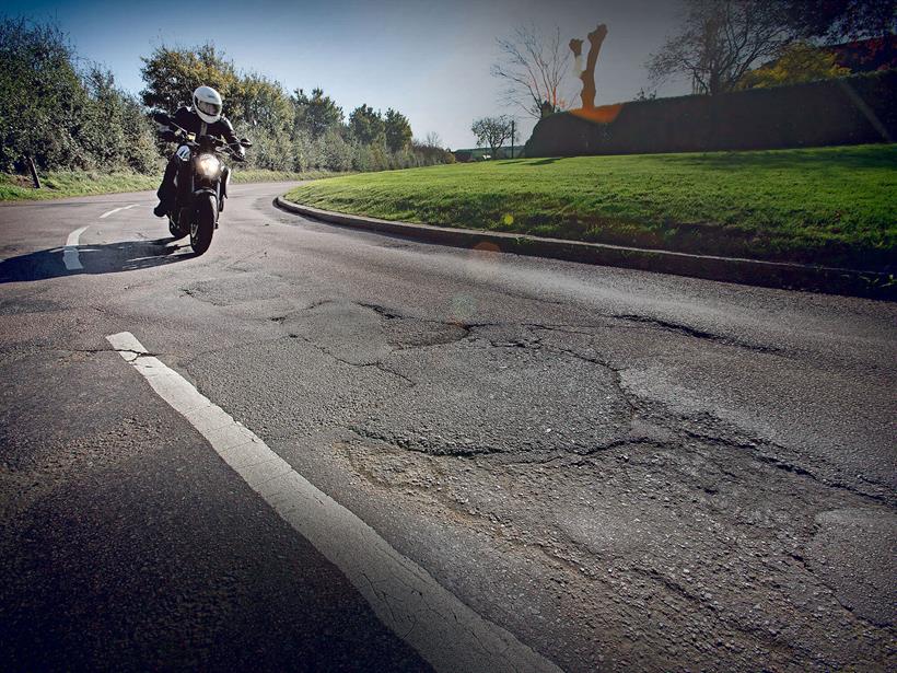 Biker approaching UK potholes