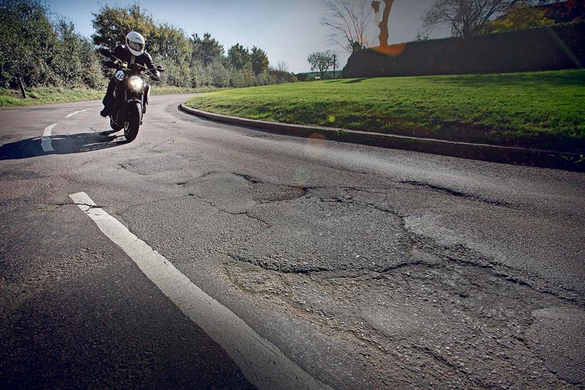 biker approaching UK potholes