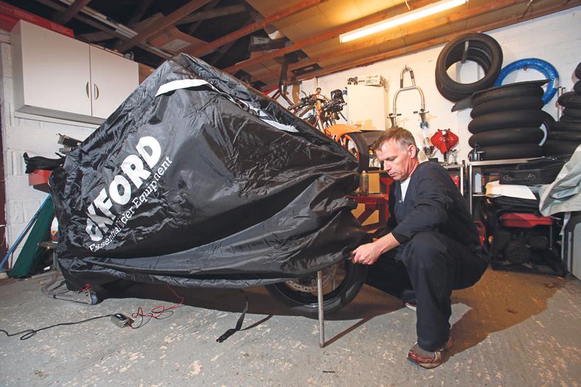 Covering a motorcycle in a garage