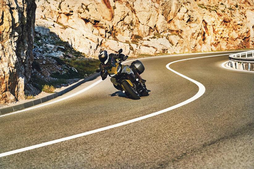 A rider corners on the BMW F900XR