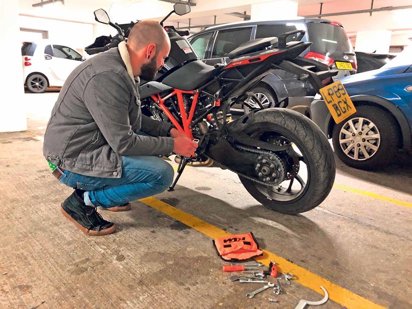 Adjusting the KTM's chain in a London carpark