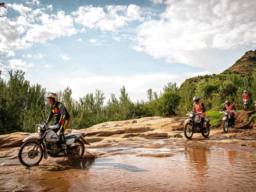 Dougie Lampkin leads the way across a shallow river bed