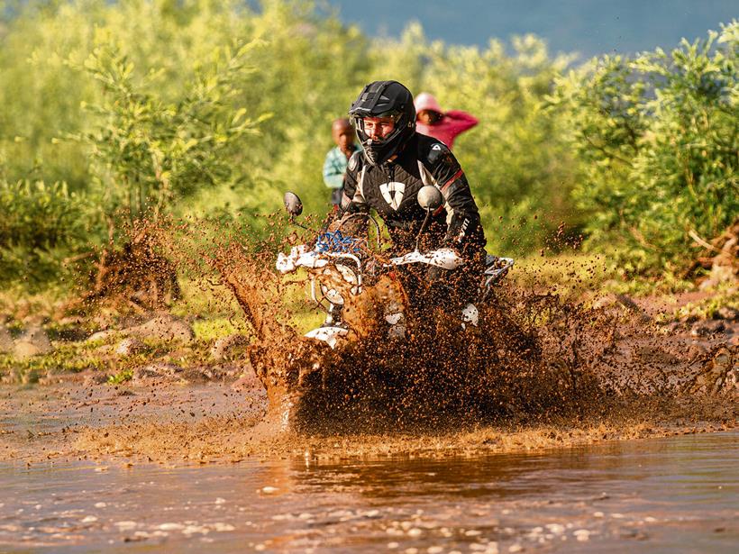 Ben Clarke wobbles across a swollen river crossing