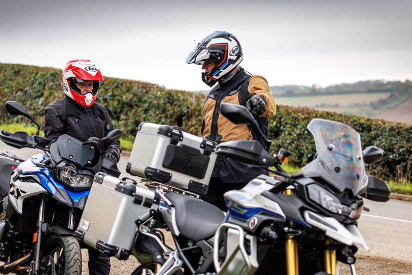 Two people chatting off stood behind a pair of bikes