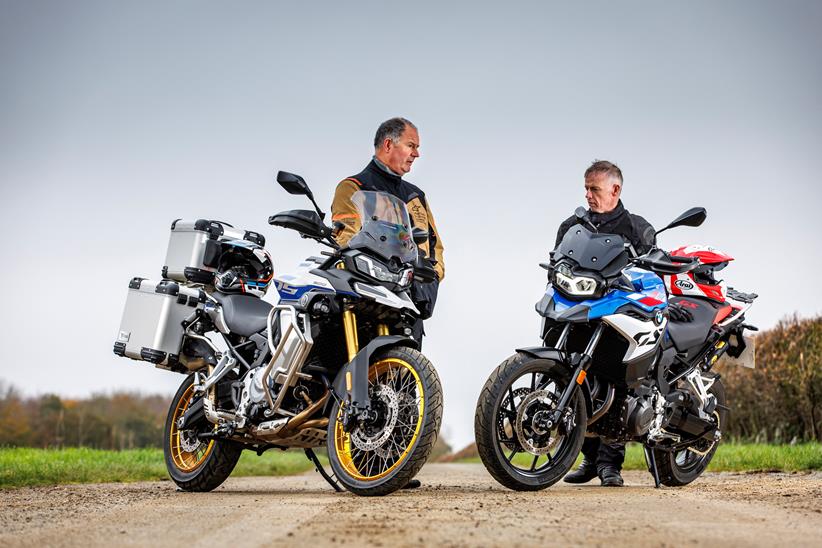 Two gentlemen discussing a pair of adventure bikes