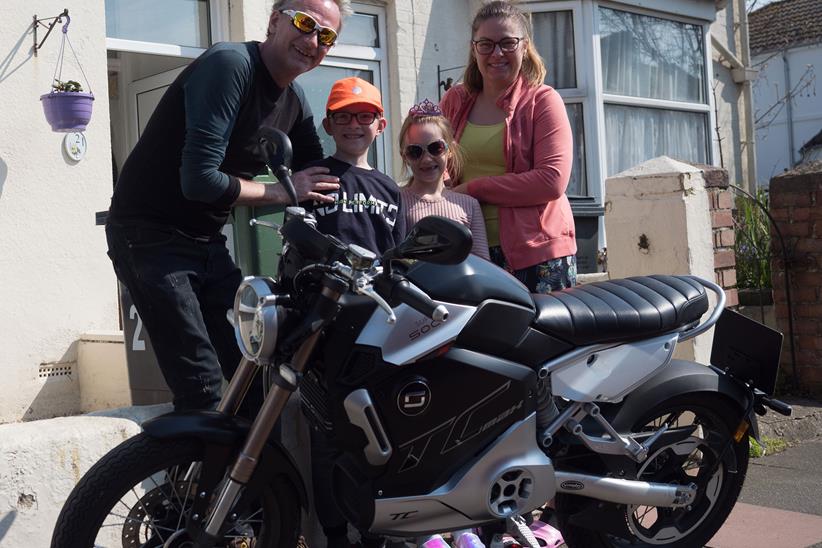 Keith Kingsbury and his family with the Super Soco TC Max he has been lent