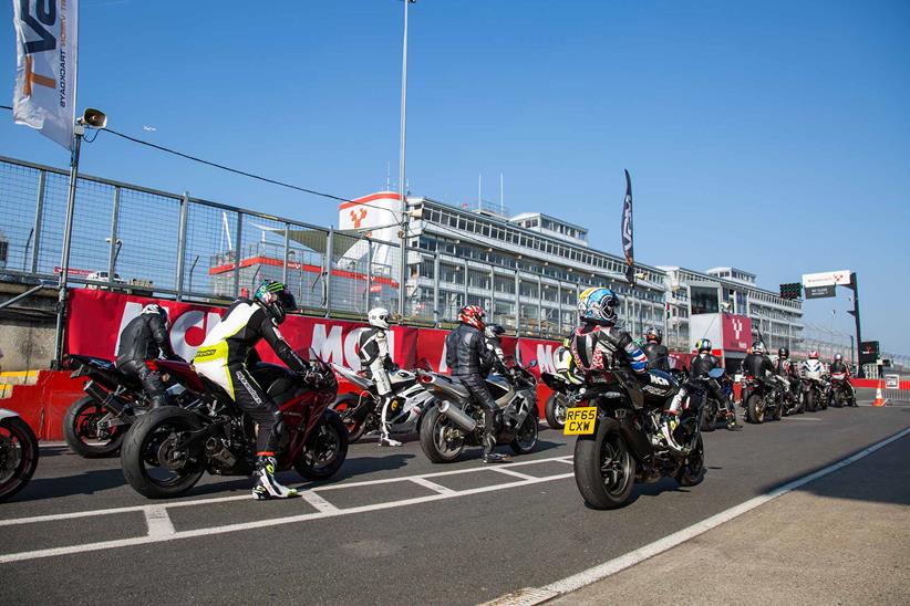 Riders wait in the pit lane at Brands Hatch