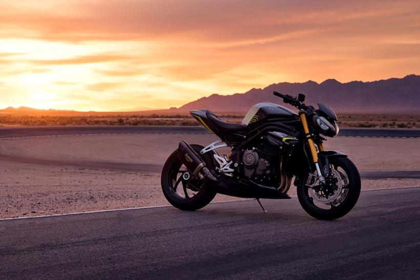 2025 Triumph Speed Triple 1200 RS under the racetrack sunset 