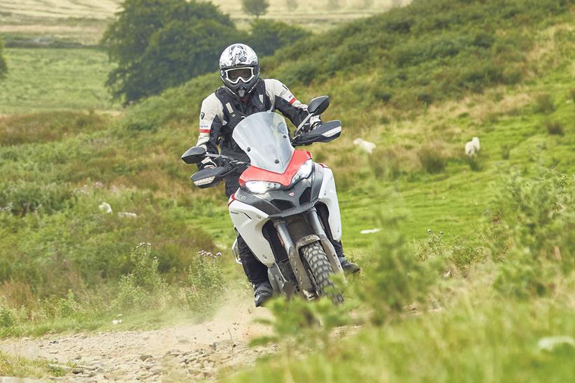 Ducati Multistrada on a green lane