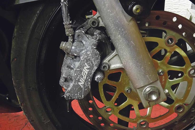 Dirty motorcycle brake caliper