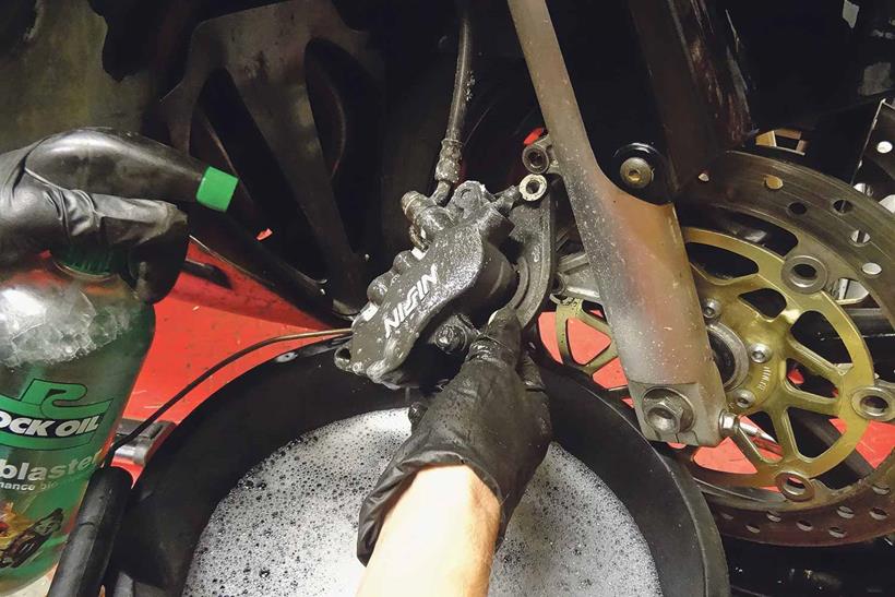 Cleaning motorcycle brake caliper