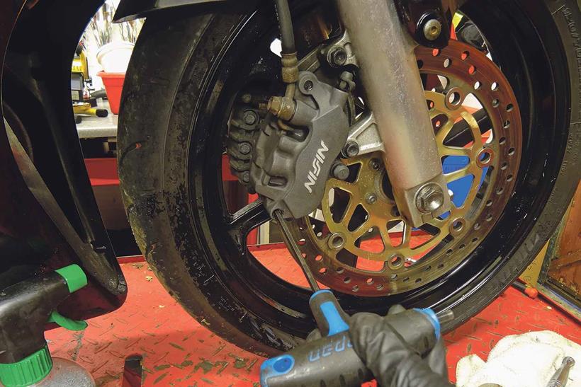 Reattaching motorcycle brake caliper