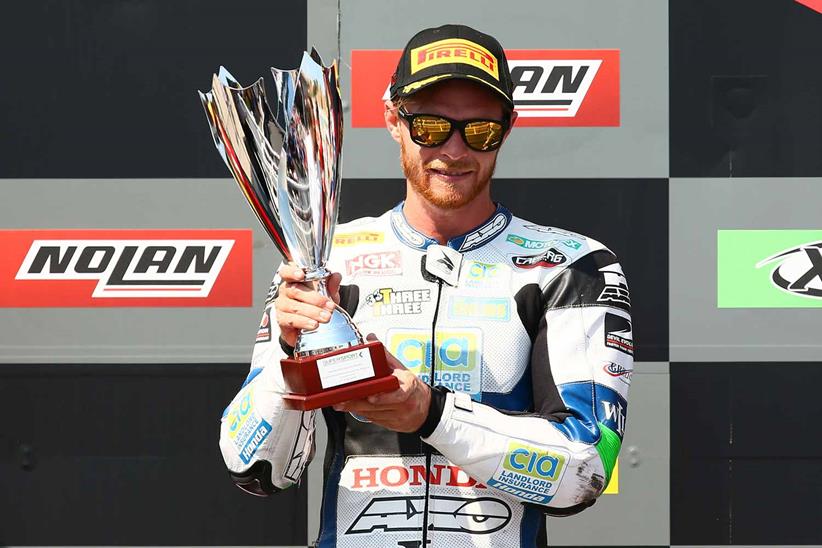 Kyle Smith celebrating on the podium at Portimao in 2018