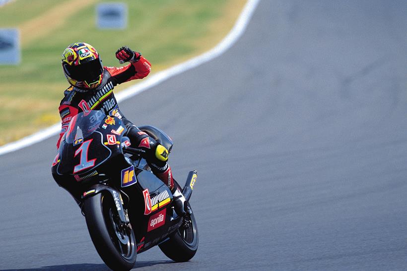 Max Biaggi rides an Aprilia 250 at Donington Park, England