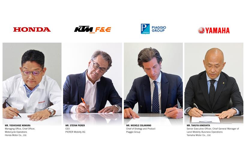 Key members of the Swappable Batteries Motorcycle Consortium sign the agreement