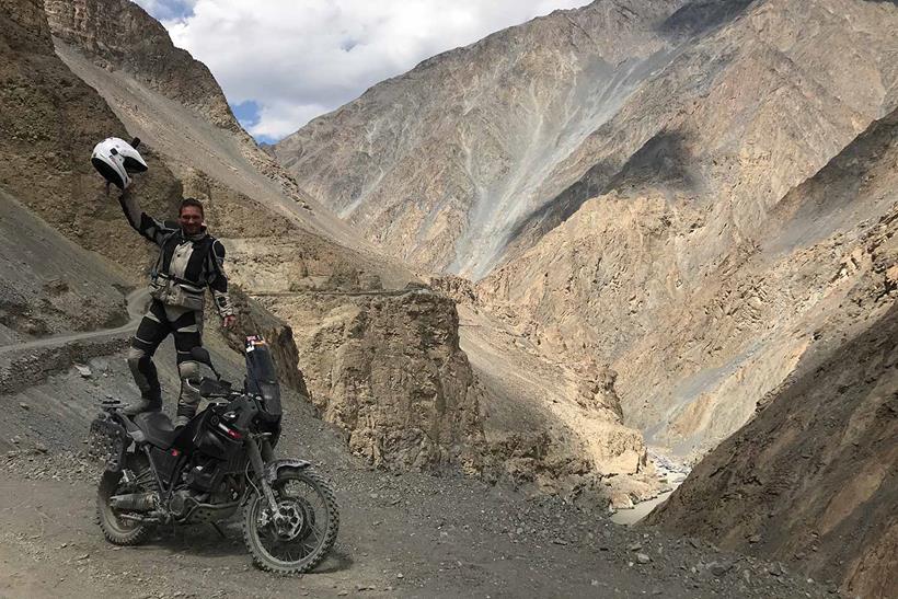 Standing on the Yamaha in a rocky valley