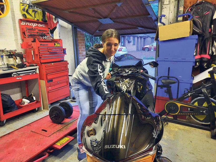 Emma moves the Suzuki Hayabusa around the garage