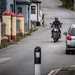 Moto Guzzi V7 rides through seaside village