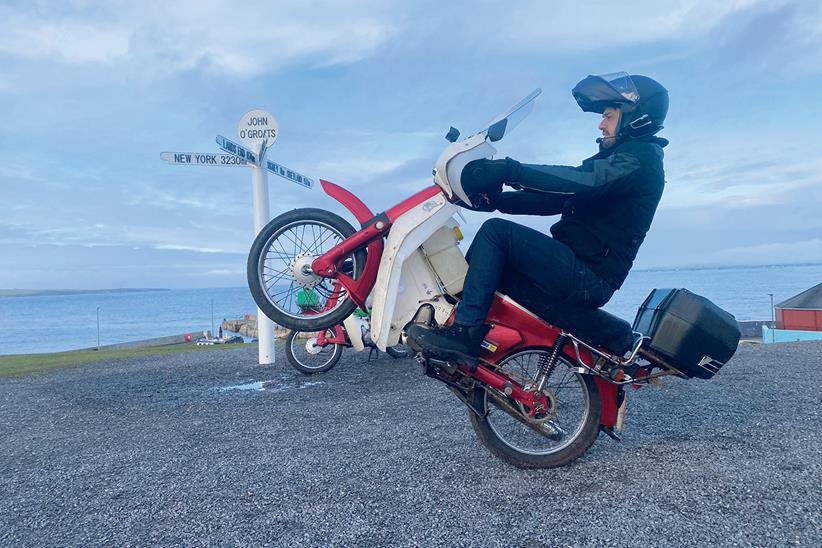 James Hillier pops a wheelie on his Honda C90