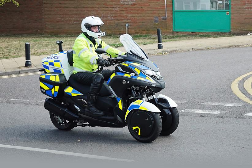 White Motorcycle Concepts WMC300FR ridden by a police officer