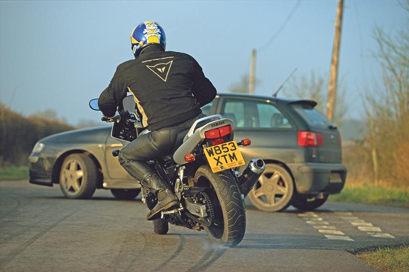 Motorcycle locks up approaching a car at junction