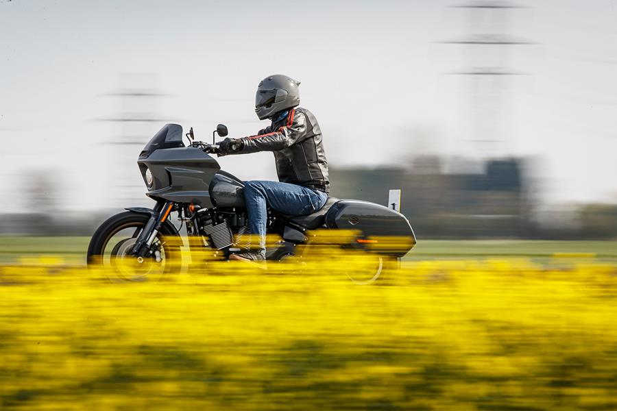 Harley-Davidson Low Rider ST riding past a yellow field